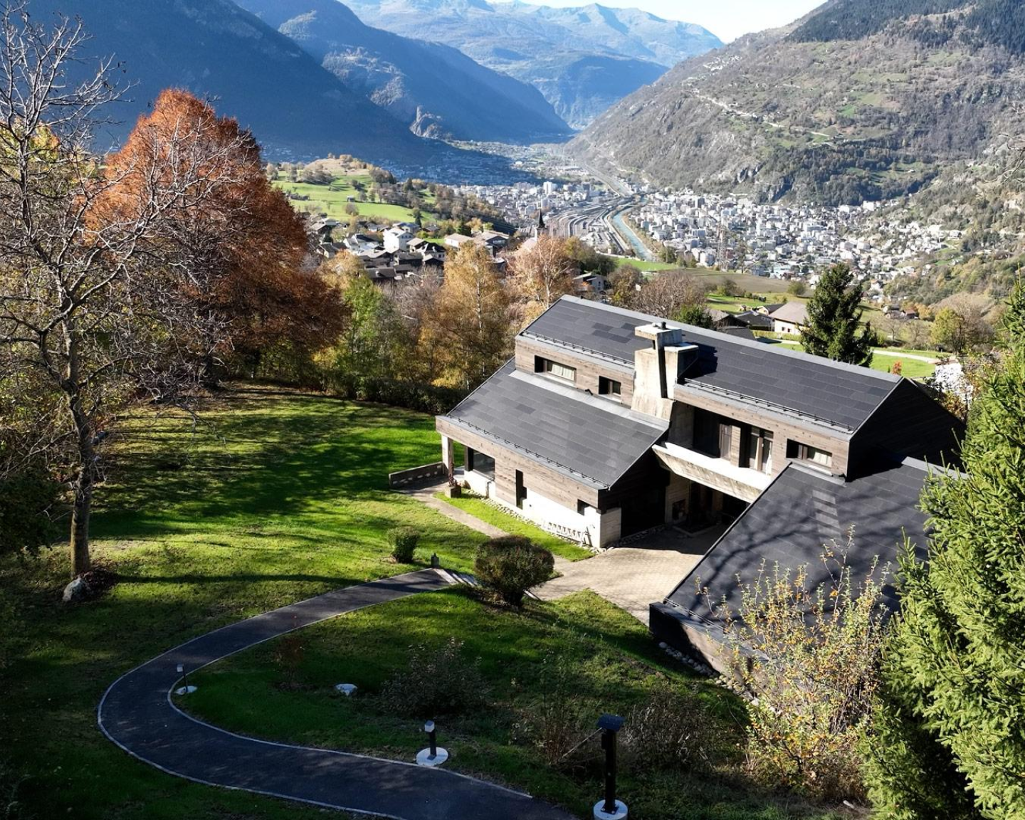 house in the mountains with solar tiles on the roof